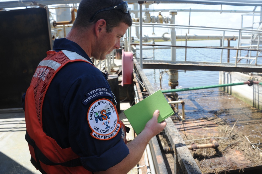 Sailor inspects facility for oil pollution