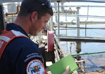 Sailor inspects facility for oil pollution