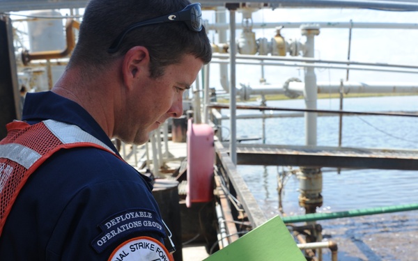Sailor inspects facility for oil pollution
