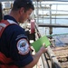 Sailor inspects facility for oil pollution