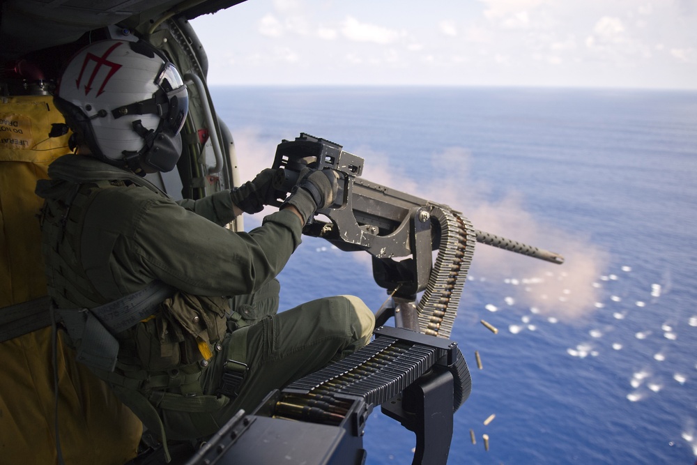 Sailor fires machine gun