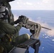 Sailor fires machine gun