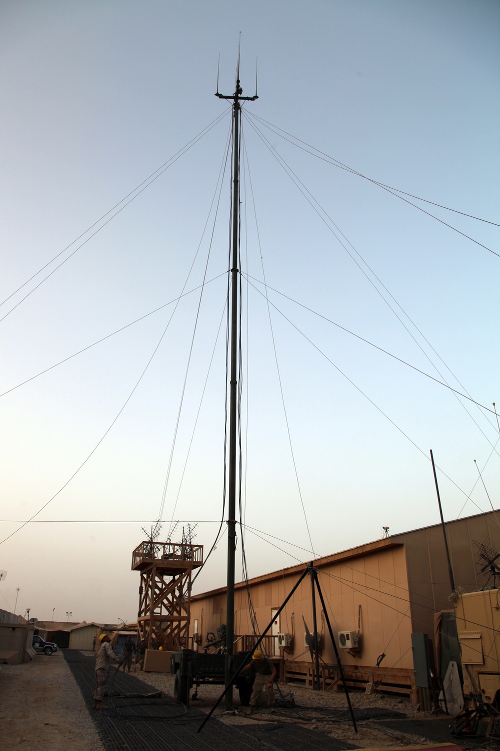 Lowering a tactical elevated antenna mast system