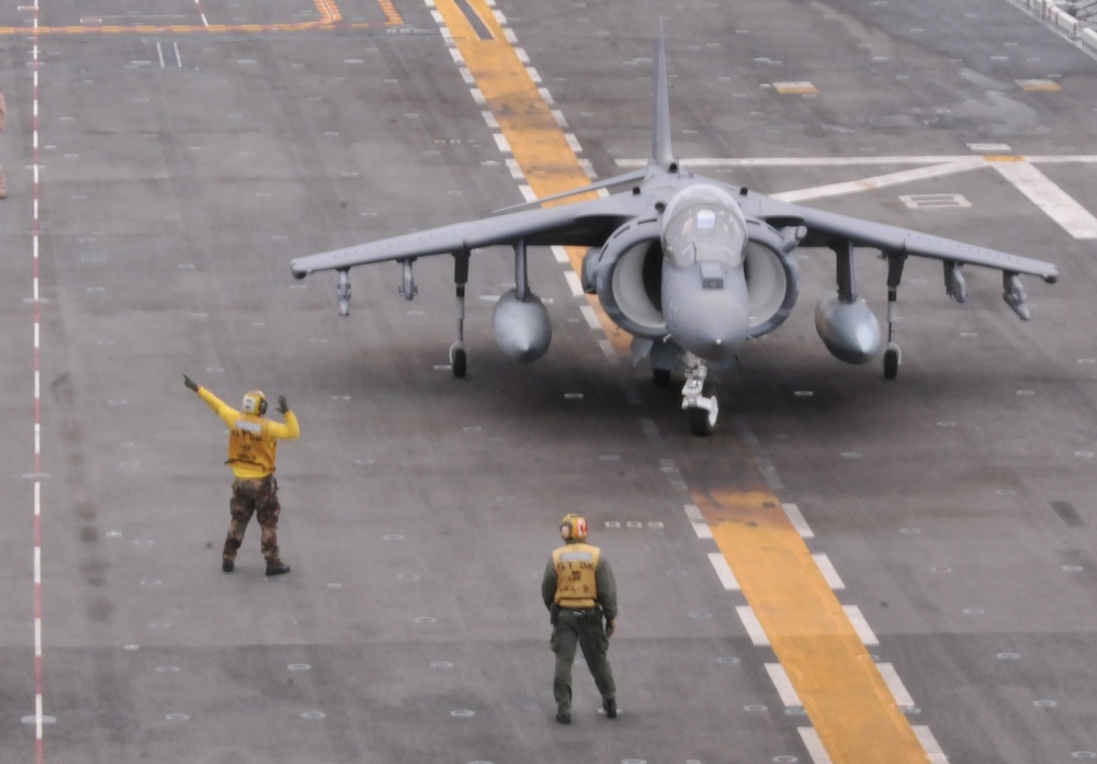 Sailors direct an AV-8B Harrier