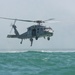 Sailors prepare to dive from SH-60 Seahawk