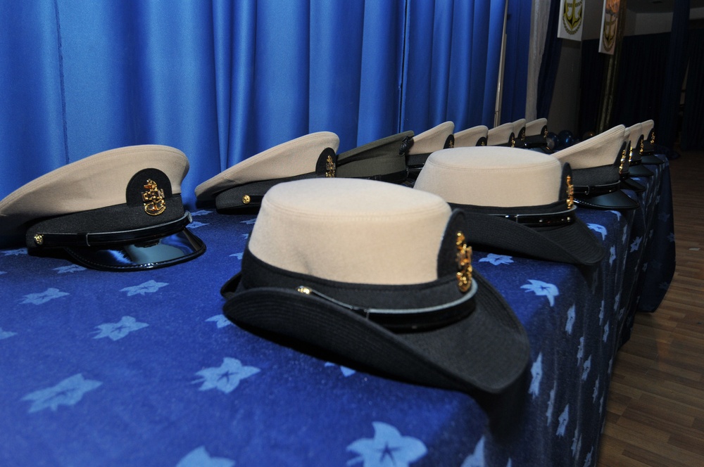 Chief selectees had anchors pinned on their lapels and their new combination covers placed on their heads per Navy tradition during the chief petty officer’s pinning ceremony at Camp Lemonnier