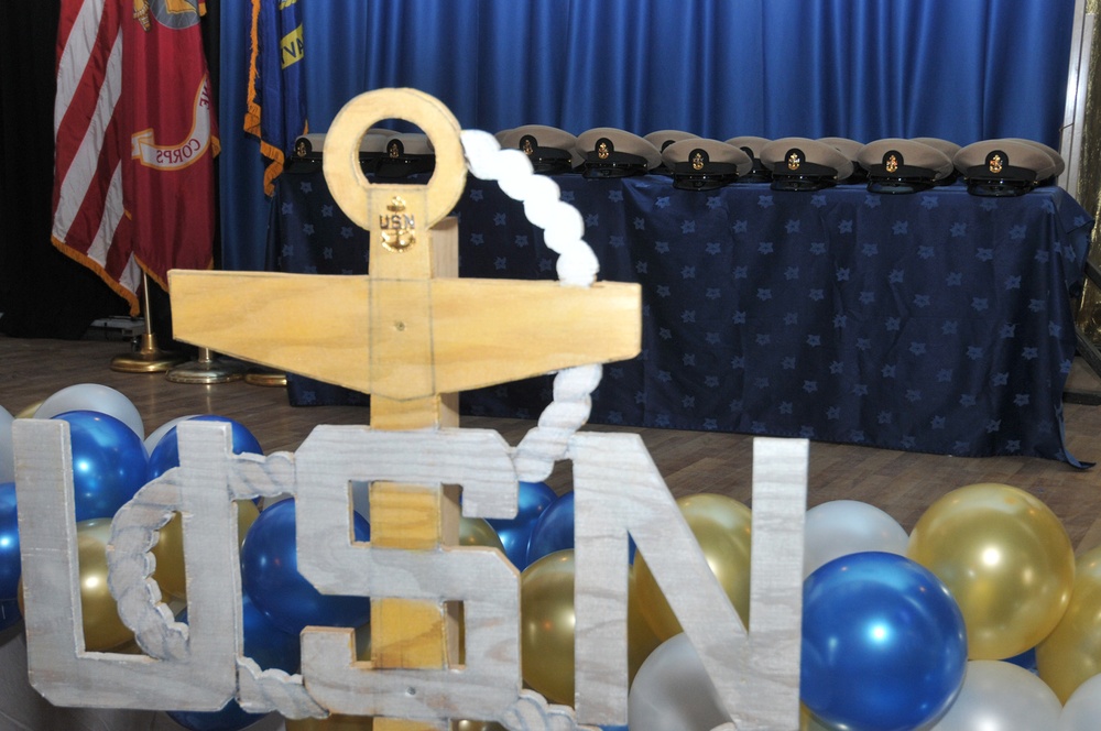 Chief selectees had anchors pinned on their lapels and their new combination covers placed on their heads per Navy tradition during the chief petty officer’s pinning ceremony at Camp Lemonnier