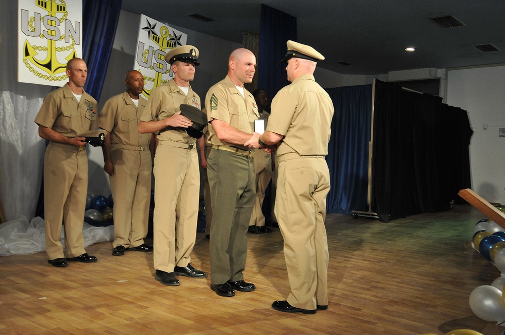 Honorary chief petty officer selectee Gunnery Sgt. Jerome Statema receives anchors and combination cover during the chief petty officer’s pinning ceremony at Camp Lemonnier