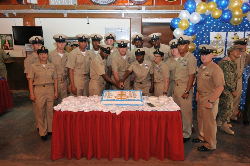 Camp Lemonnier command master chief and the 20 new chief petty officers cut a cake after the chief petty officer’s pinning ceremony at Camp Lemonnier