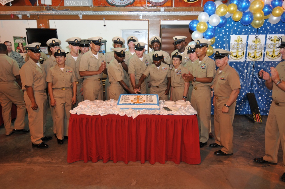Camp Lemonnier command master chief and the 20 new chief petty officers cut a cake after the chief petty officer’s pinning ceremony at Camp Lemonnier