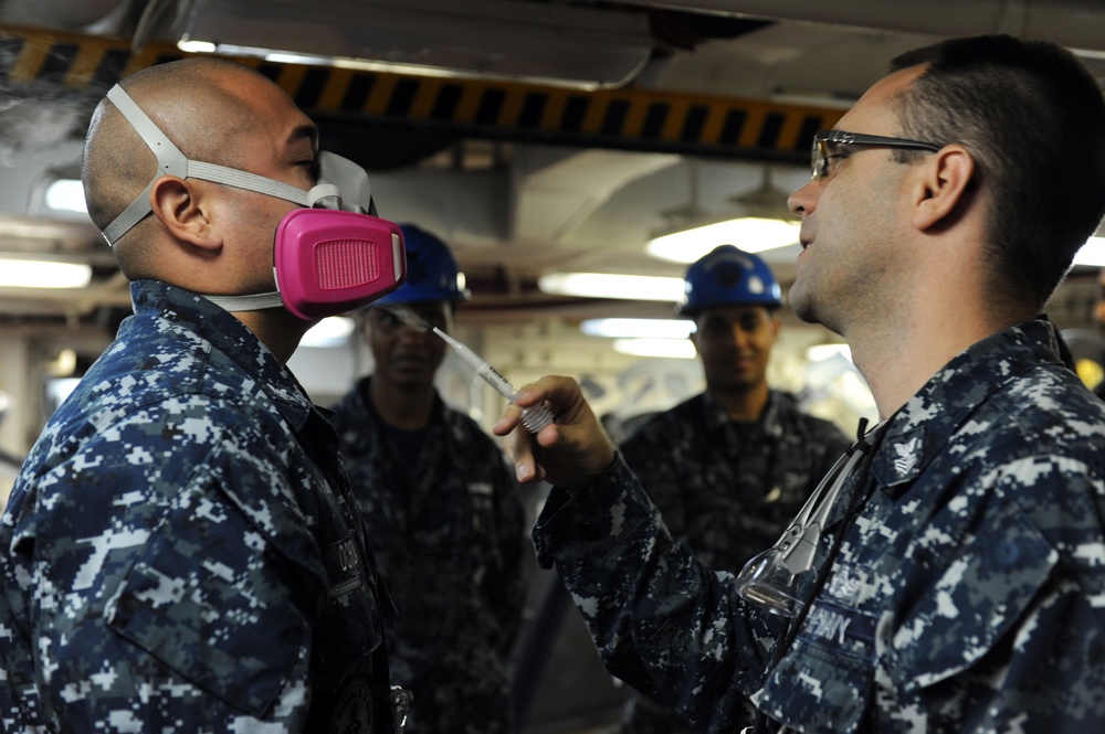 USS George H.W. Bush sailors perform respirator fit test