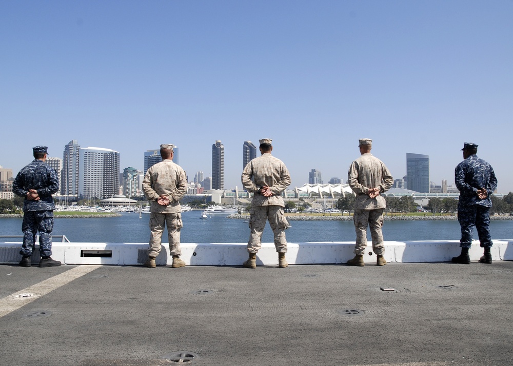 Sailors and Marines man USS Green Bay's rails