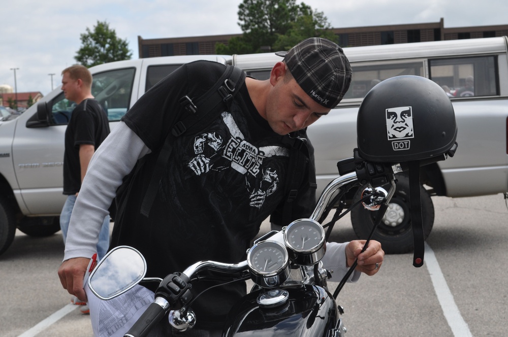 Motorcyclists tour vintage car showroom