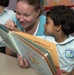 Sailor reads with child during community service