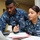 USS Ronald Reagan sailors process purchases USS Ronald Reagan sailors process purchases