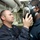 USS Hue City sailor helps another with gas mask USS Hue City sailor helps another with gas mask