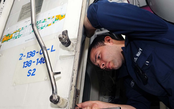 USS George H.W. Bush sailors perform maintenance