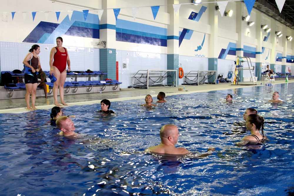 Marines, sailors and Marine Corps Community Services fitness instructors assemble in the IronWorks pool here Sept. 6, 2012, to take part in Marine Corps Aquatics Cadence Reconditioning Program Training