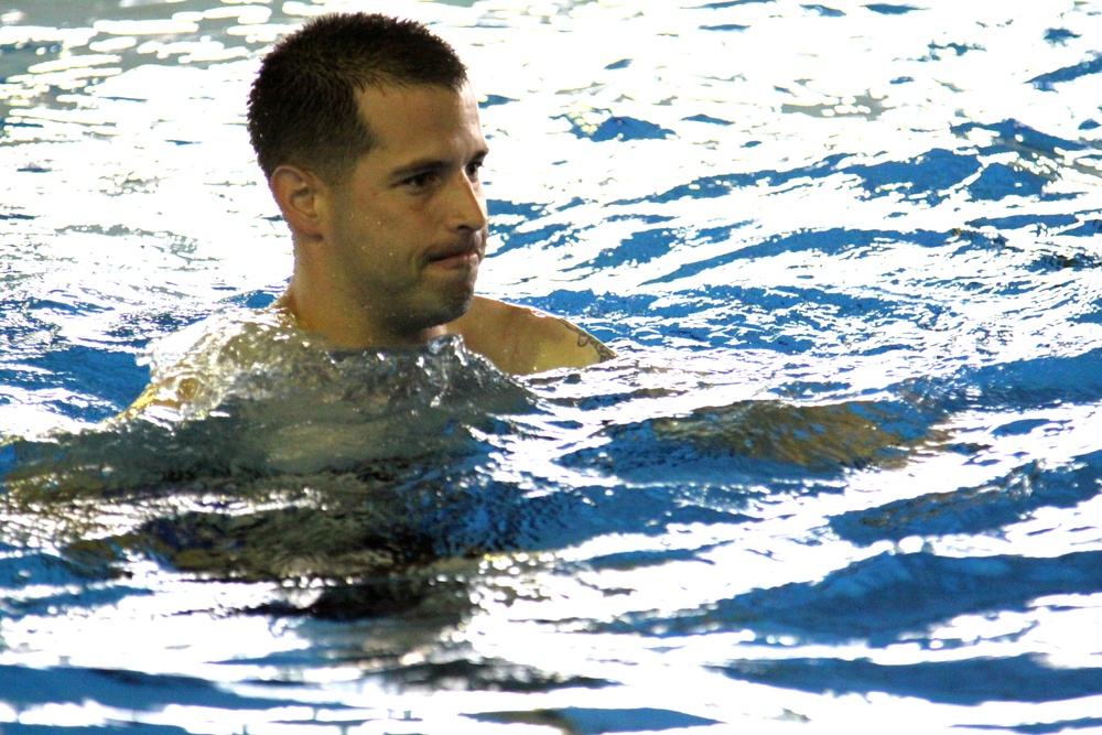 Staff Sgt.  Roman Barabash, Marine Aviation Logistics Squadron 12 ground support equipment mechanic, runs through the water during the Marine Corps Aquatics Cadence and Reconditioning Program Training at the IronWorks pool here Sept. 6, 2012