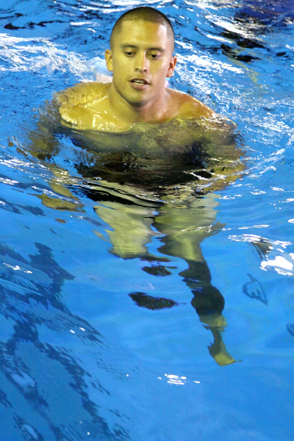 Sgt. Christopher Flores, Marine Wing Support Squadron 171 engineers platoon sergeant, runs through the water during the Marine Corps Aquatics Cadence and Reconditioning Program Training at the IronWorks pool here Sept. 6, 2012