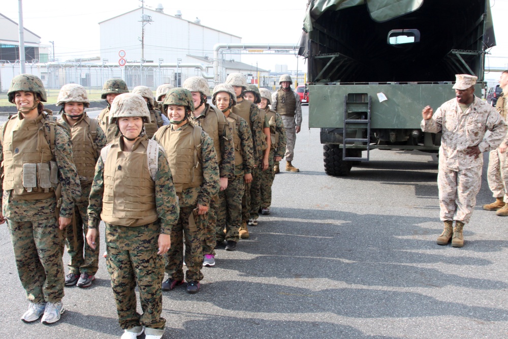 Gunnery Sgt. Timothy L. Thompson, Marine Wing Support Squadron 171 bulk fuels specialist and acting senior drill instructor of Jane Wayne Day, marches the spouse volunteers of MWSS-171 to the gas chamber here Sept. 14, 2012