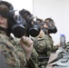 Marine Wing Support Squadron 171 spouses test their gas masks during a brief on what they can expect from the gas chamber during Jane Wayne Day here Sept. 14, 2012