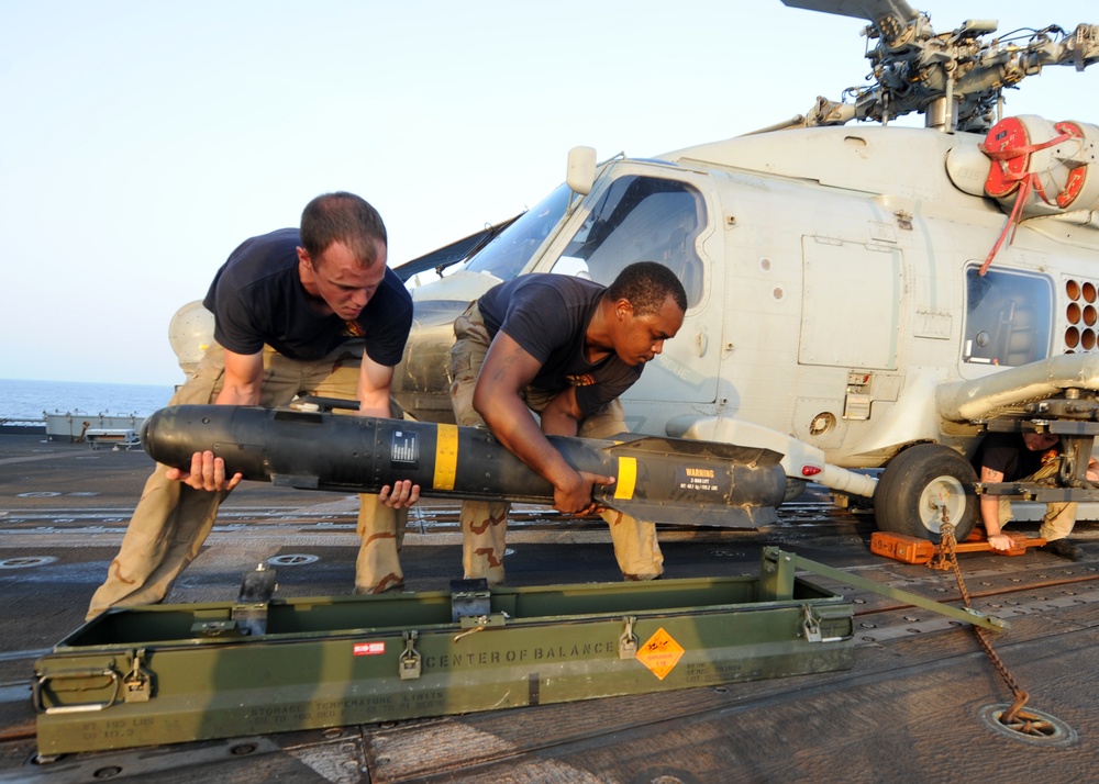 HSL 46 sailors load missiles onto a Sea Hawk