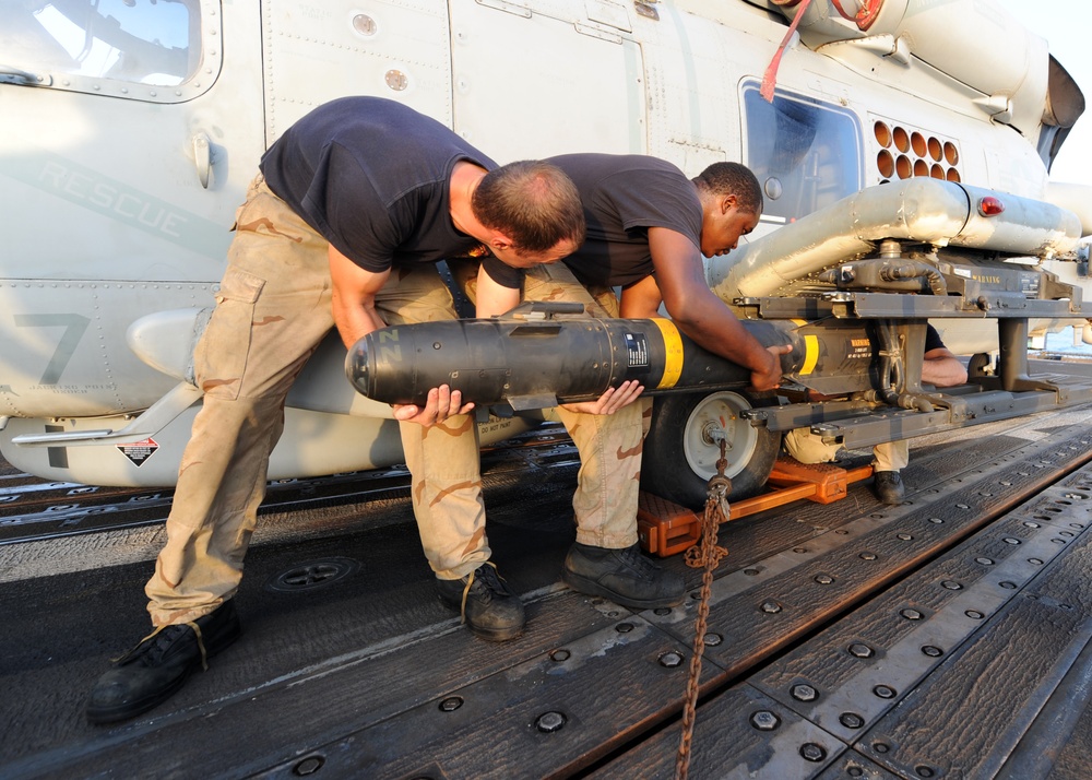 HSL 46 sailors load missiles onto a Sea Hawk