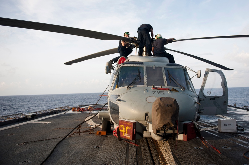Performing maintenance on an SH-60 helicopter