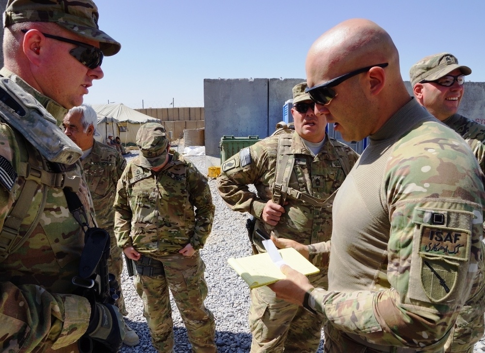 Soldiers discuss security strategy during a mission in southern Afghanistan