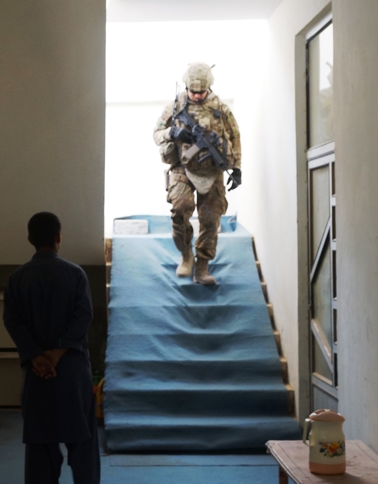 A Kentucky soldier returns from security checks on a roof in southern Afghanistan