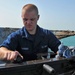 USS New York sailor performs maintenance