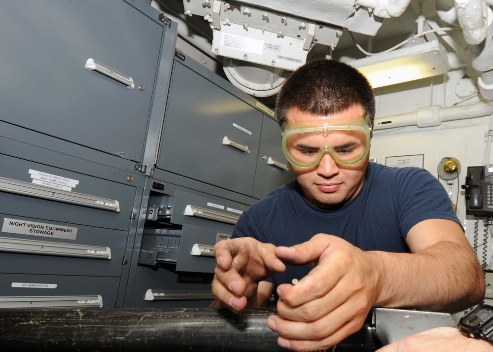 USS George H.W. Bush sailor at work