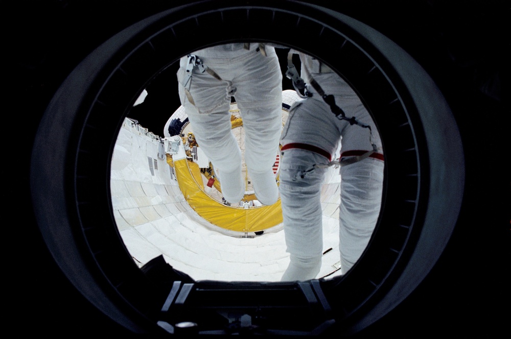 EVA Crewmembers emerging from the air lock into the middeck.