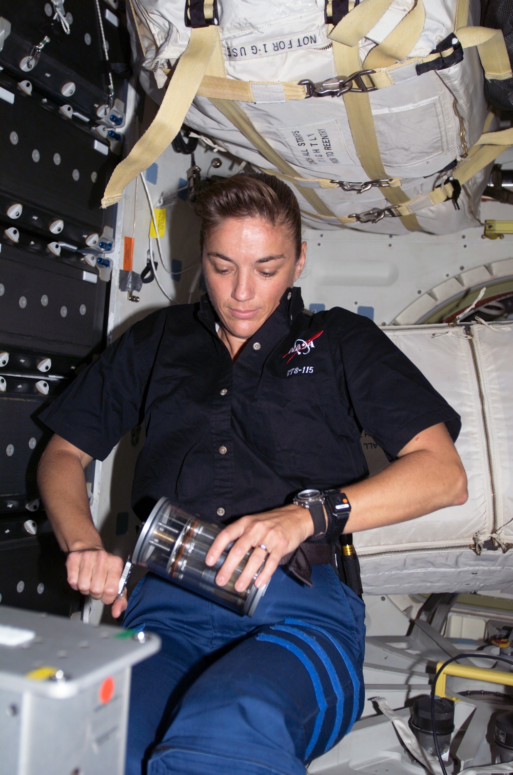 STS-115 MS MacLean holds Yeast GAP in the FWD MDDK of the Space Shuttle Atlantis during Joint Operations