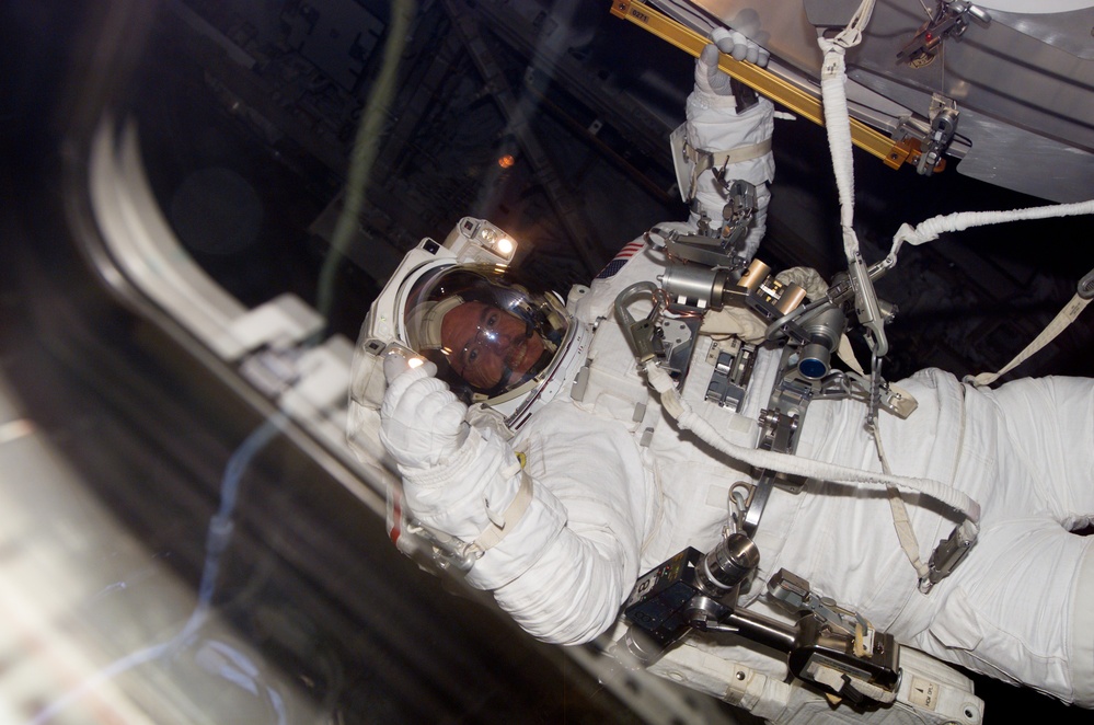 Reilly performing EVA 3 from the aft FD window