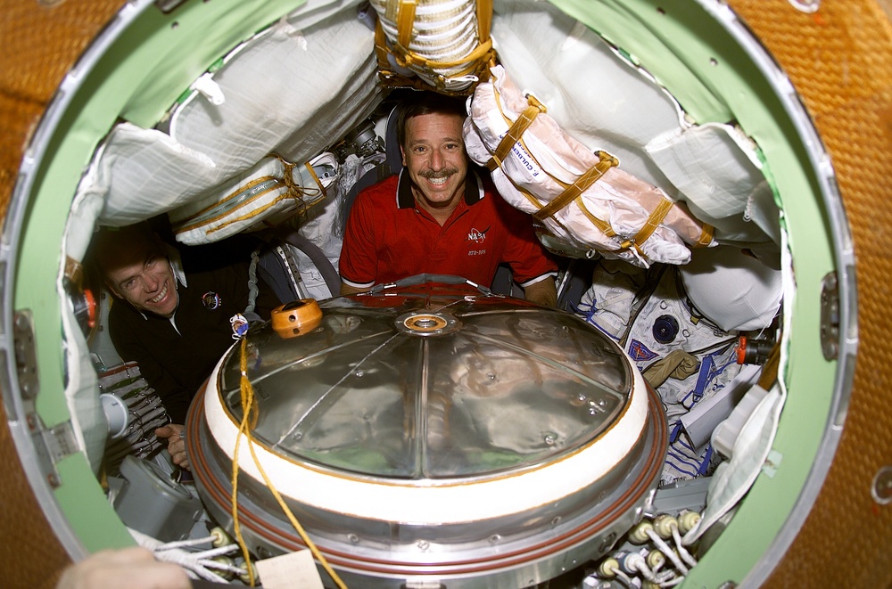 Horowitz and Barry inside Soyuz spacecraft with Sokol suits