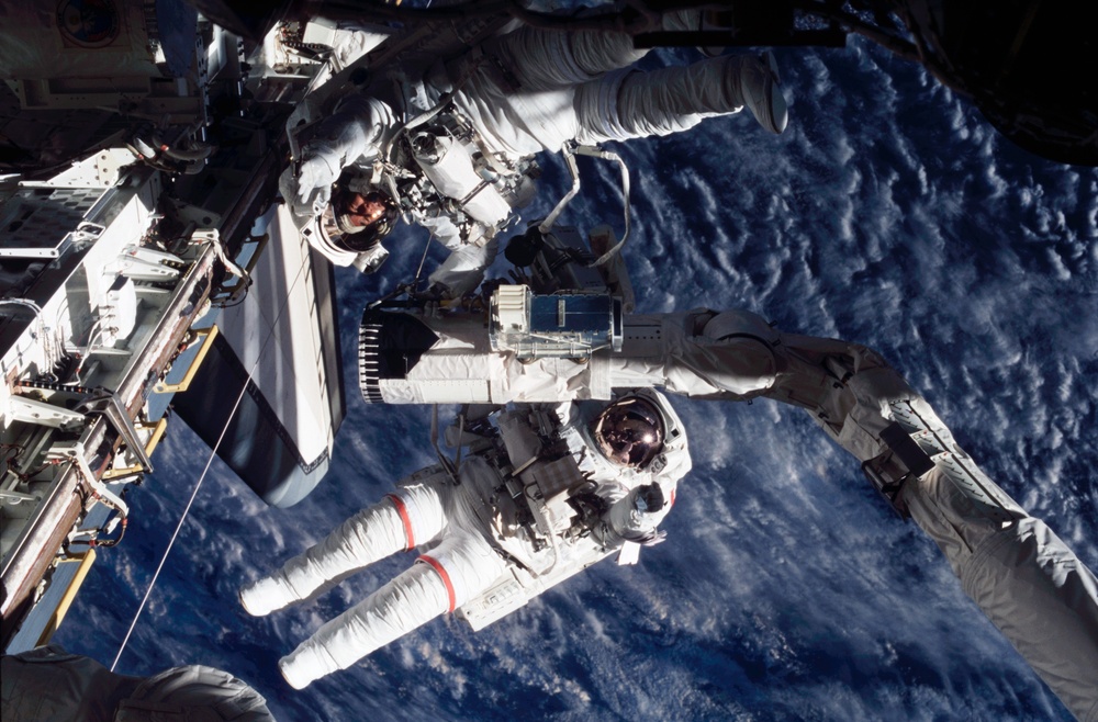 MS Godwin and MS Tani grab hold of the RMS during STS-108's EVA