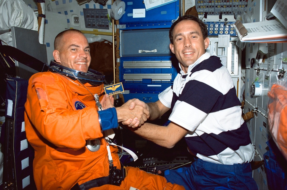 Newman assists Sturckow with his LES after insertion into orbit