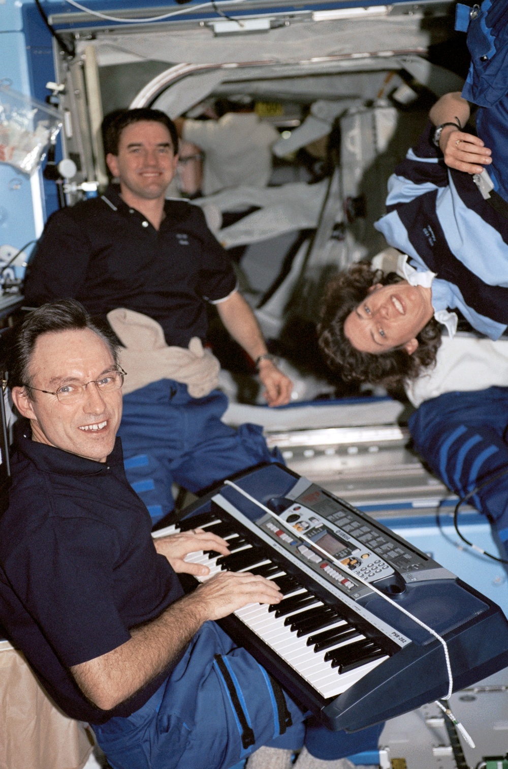Carl Walz plays the piano for the STS-110 crew in the U.S. Laboratory