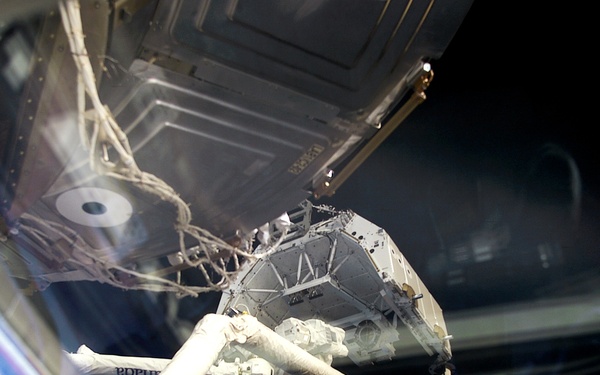 MS Hadfield works at the RMS controls on the flight deck of Endeavour during RMS handshake
