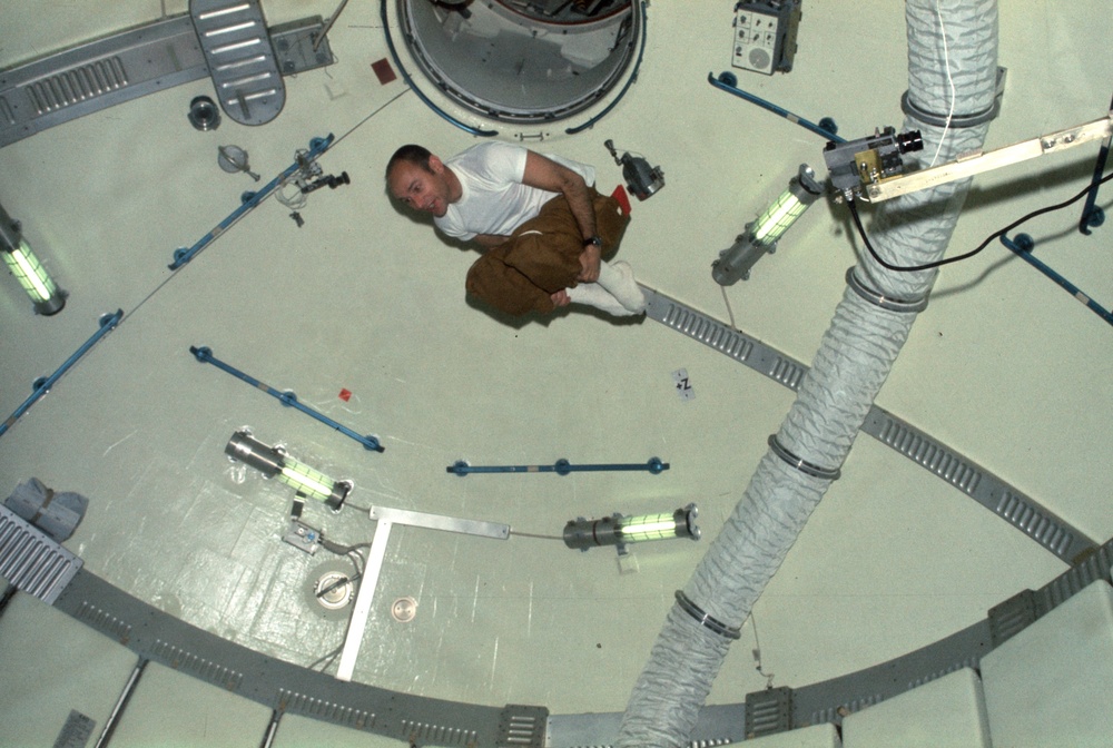 Astronaut Alan Bean doing acrobatics in OWS dome area