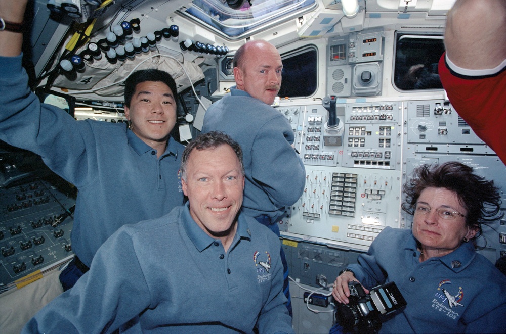 STS-108 crew pose on the flight deck of Endeavour