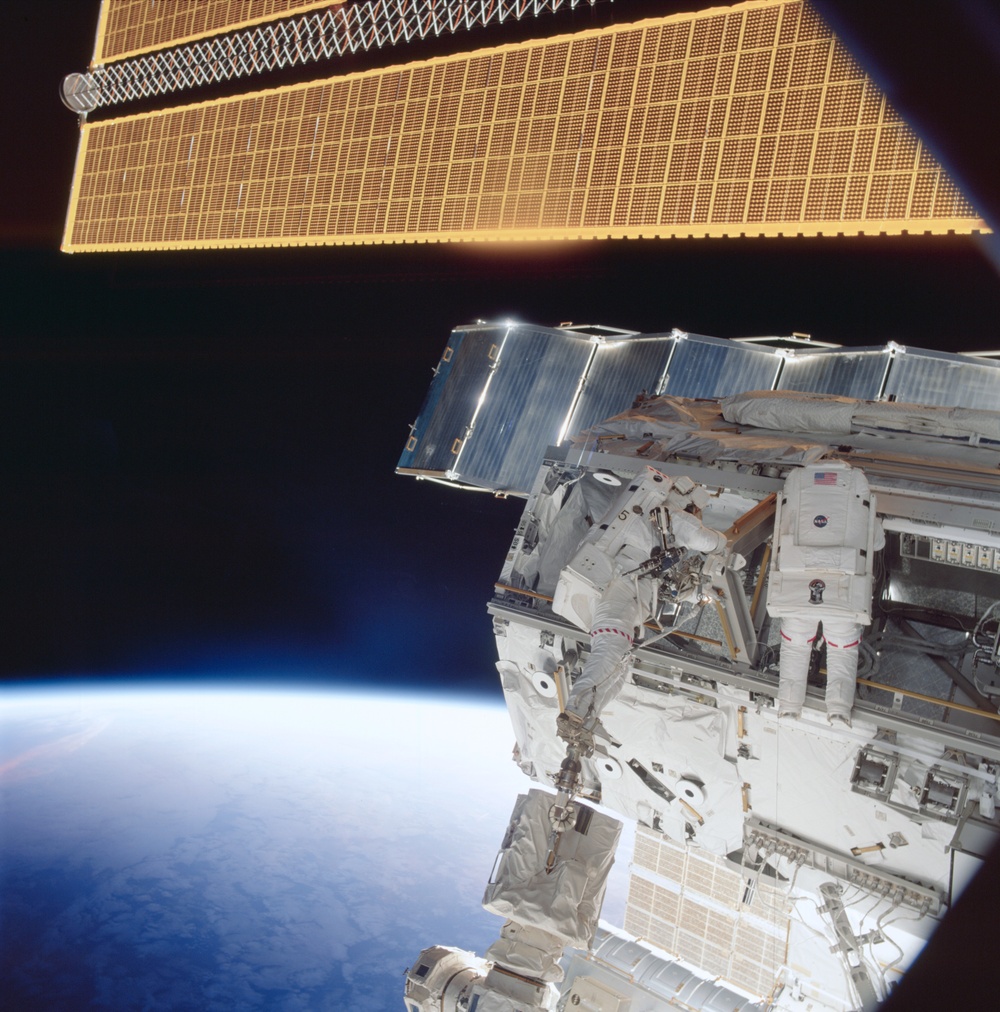 Morin and Ross work on a keel pin for the S0 Truss during the second EVA of STS-110