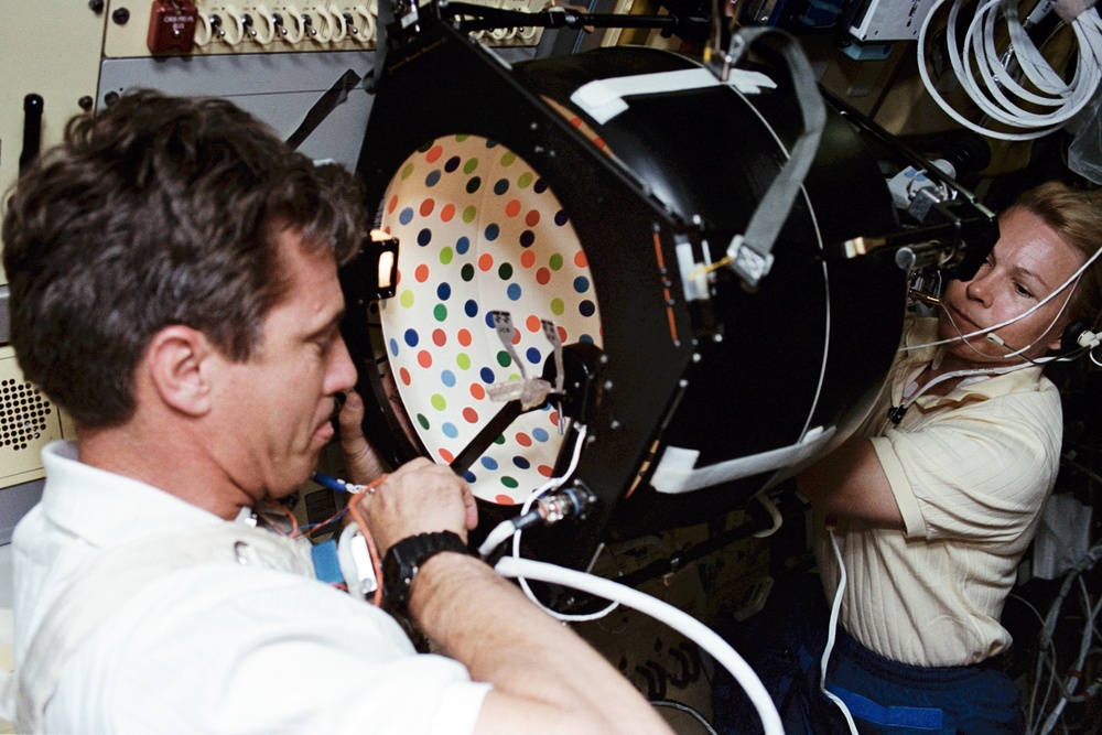 Crewmembers in the spacelab with the Rotating Dome vestibular experiment.