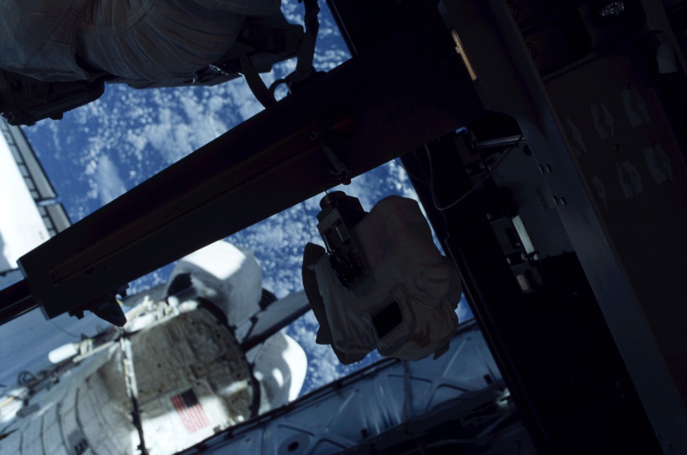 View of a F5 camera tethered to a handrail during the second EVA of STS-110