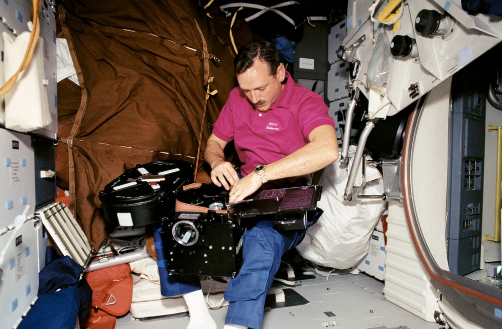 Akers loads film into the IMAX camera