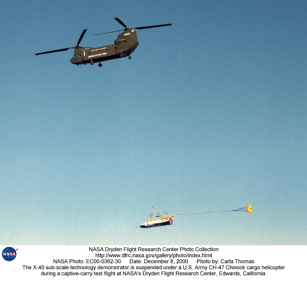 The X-40 sub-scale technology demonstrator is suspended under a U.S. Army CH-47 Chinook cargo helico