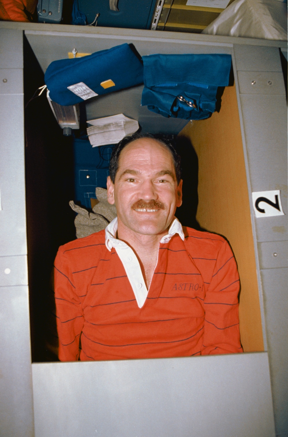 STS-35 Pilot Gardner in sleep station compartment on OV-102's middeck