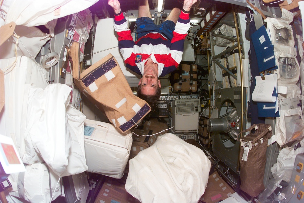 MS Reilly clings to the ceiling of the Spacehab